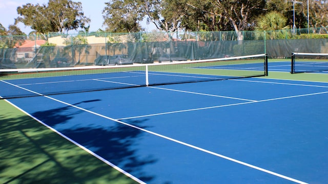 view of tennis court featuring fence