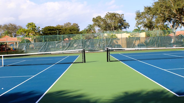 view of sport court featuring fence