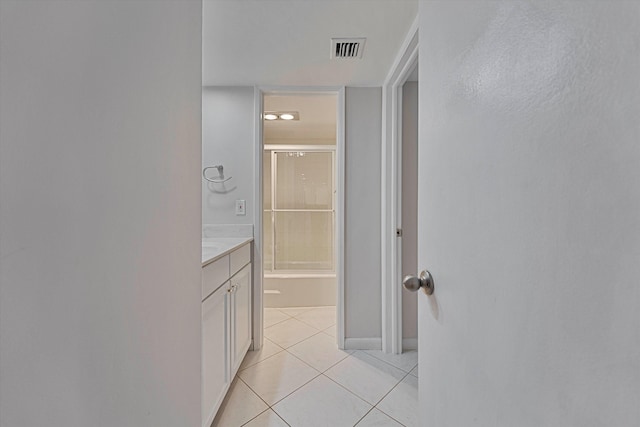 bathroom with tile patterned flooring, washtub / shower combination, visible vents, and vanity