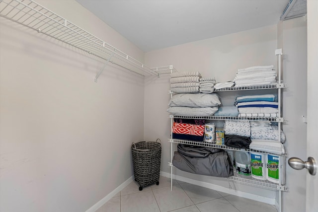 walk in closet with tile patterned flooring