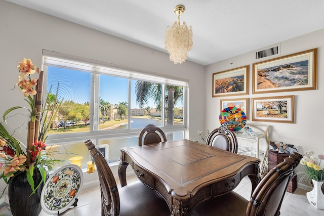 dining room featuring an inviting chandelier, baseboards, visible vents, and light tile patterned flooring