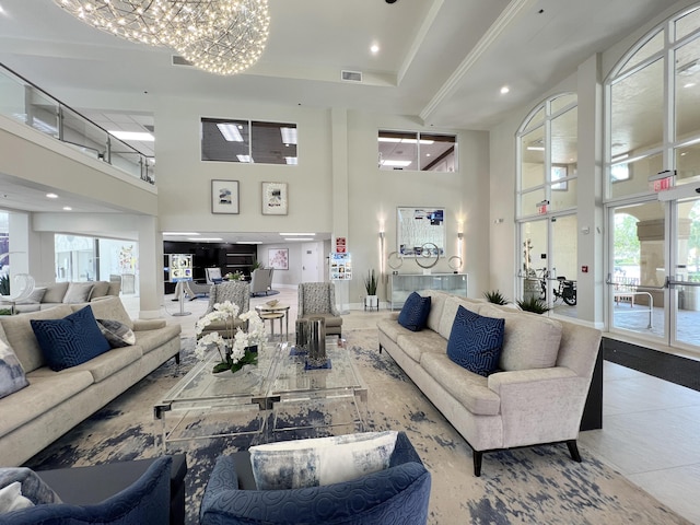 living area with recessed lighting, visible vents, a towering ceiling, an inviting chandelier, and baseboards