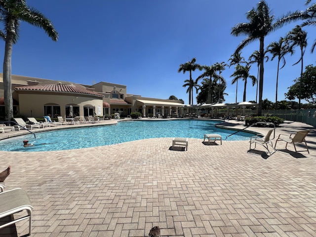 community pool featuring a patio area and fence