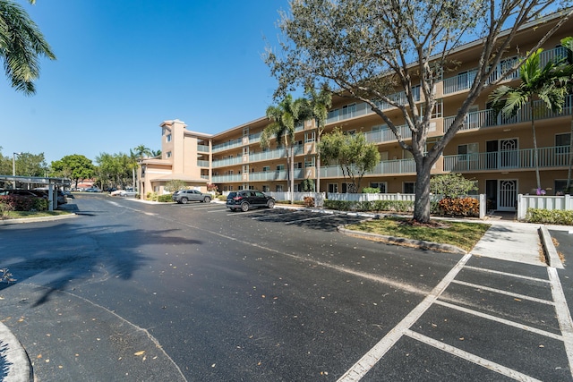 view of building exterior with uncovered parking