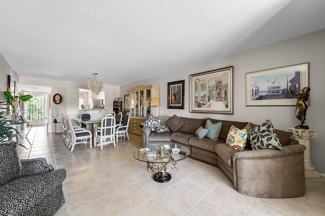 living room with a textured ceiling and light tile patterned floors