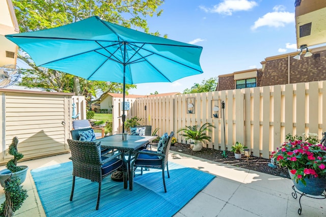 view of patio featuring fence and outdoor dining area