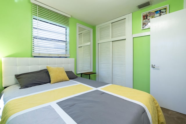 bedroom with visible vents and a closet