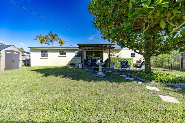 rear view of house with a lawn, stucco siding, an outdoor structure, a fenced backyard, and a pergola