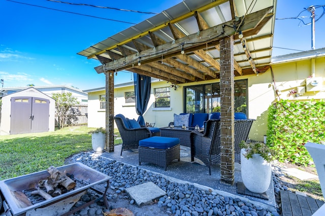 view of patio / terrace with an outbuilding, fence, a shed, and an outdoor hangout area