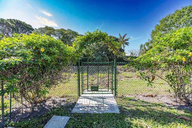 view of yard featuring fence and a gate