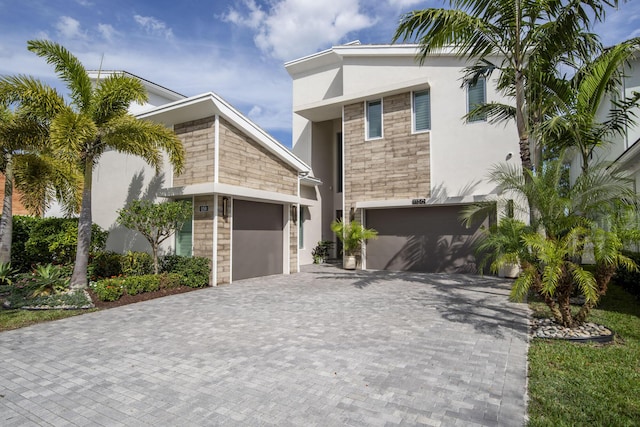 view of front of property with decorative driveway and stucco siding