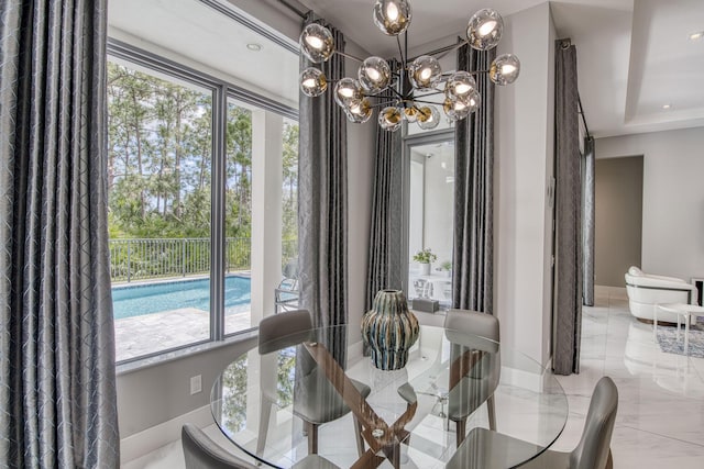 dining room with baseboards, marble finish floor, plenty of natural light, and a notable chandelier