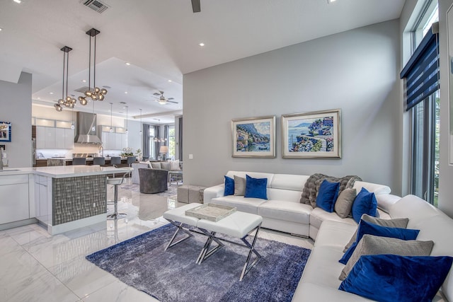 living room with visible vents, marble finish floor, a ceiling fan, and recessed lighting