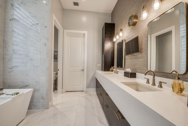 bathroom featuring marble finish floor, visible vents, a sink, and double vanity