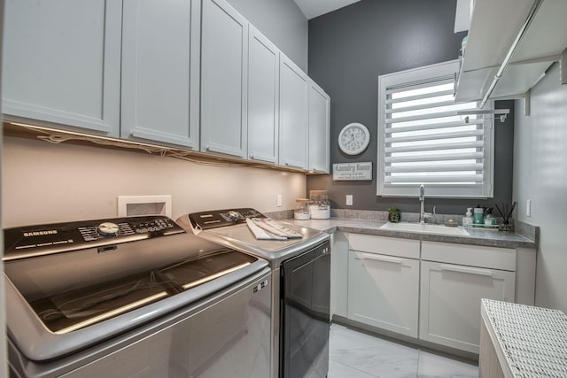 laundry area featuring washer and dryer, marble finish floor, cabinet space, and a sink