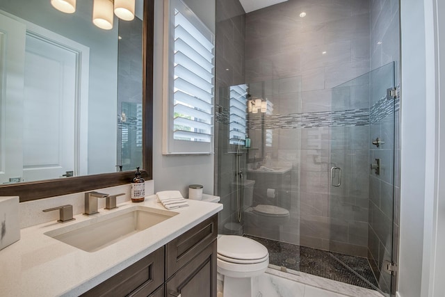 bathroom with a stall shower, marble finish floor, vanity, and toilet