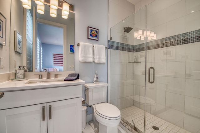 full bathroom with toilet, a shower stall, and vanity