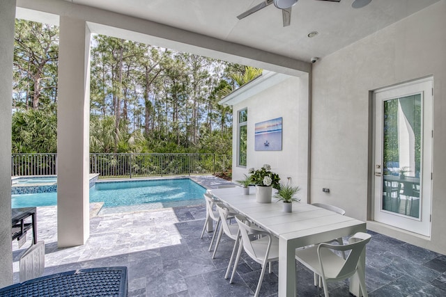 view of swimming pool with a ceiling fan, outdoor dining space, a patio area, and fence