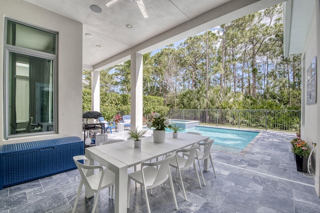 view of patio / terrace featuring a pool with connected hot tub, ceiling fan, radiator heating unit, and fence