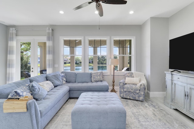 living area with recessed lighting, baseboards, and a ceiling fan