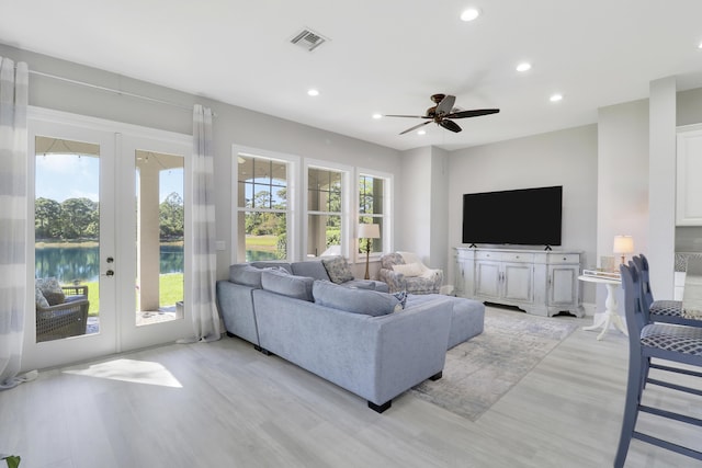 living room with plenty of natural light, french doors, and visible vents