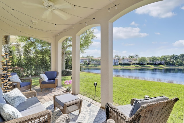 view of patio featuring a ceiling fan and a water view