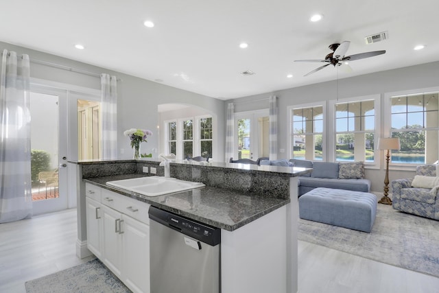 kitchen featuring visible vents, plenty of natural light, dishwasher, and a sink