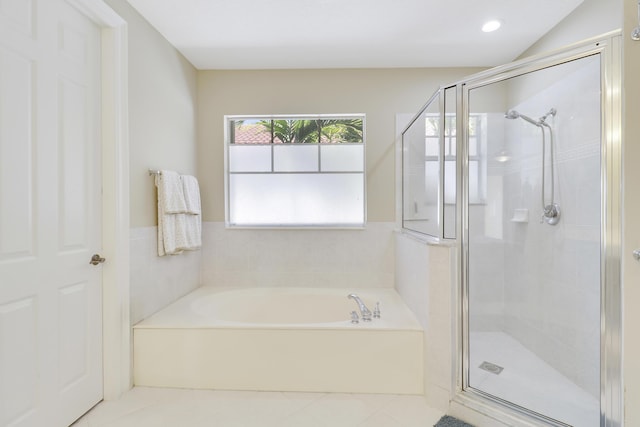 bathroom with tile patterned floors, a stall shower, and a garden tub