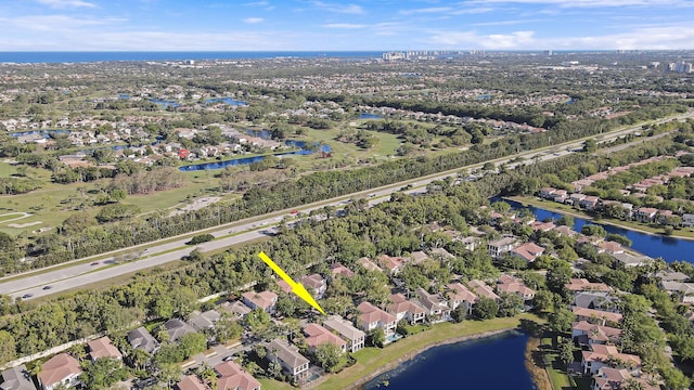 drone / aerial view featuring a residential view and a water view