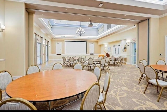 carpeted dining space with baseboards, a high ceiling, a chandelier, and ornamental molding