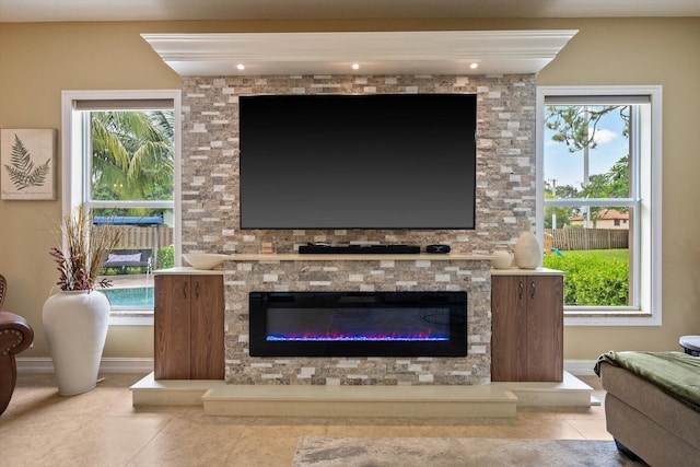 room details with a glass covered fireplace and baseboards