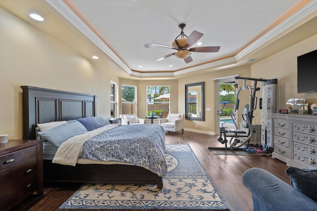 bedroom with baseboards, dark wood-type flooring, access to outside, a tray ceiling, and crown molding