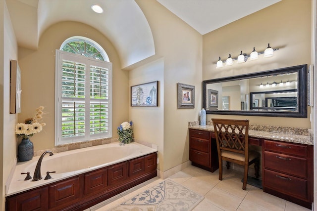 full bath featuring tile patterned flooring, a garden tub, vanity, and baseboards