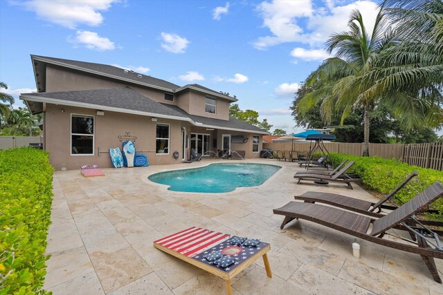 view of swimming pool featuring a patio area, a fenced backyard, a fenced in pool, and area for grilling