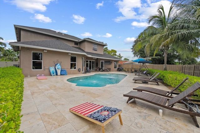 view of pool with a fenced backyard, a fenced in pool, and a patio