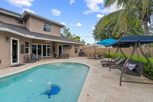 view of pool with a fenced in pool, outdoor dining area, french doors, a patio area, and a fenced backyard