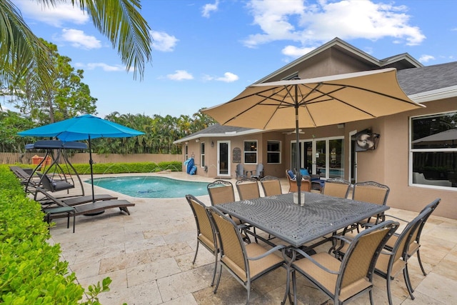 view of swimming pool featuring a fenced in pool, french doors, a patio, outdoor dining space, and fence