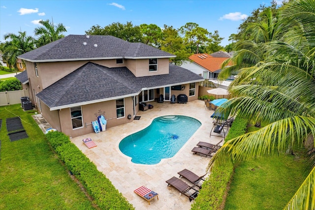 view of pool with a fenced in pool, a lawn, a patio area, cooling unit, and a fenced backyard