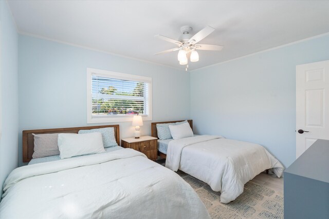 bedroom with crown molding, multiple windows, and a ceiling fan