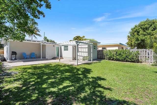 back of property featuring stucco siding, a pergola, a patio, fence, and a yard