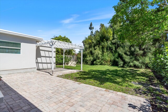 view of yard featuring a patio area, fence, and a pergola