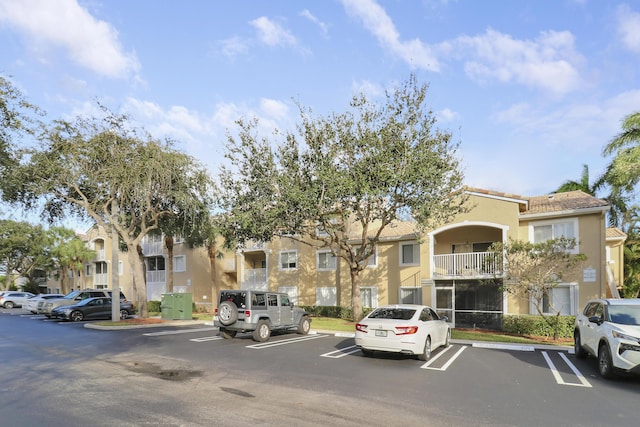 view of property with uncovered parking and a residential view