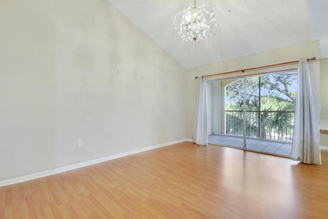 unfurnished room with a chandelier, vaulted ceiling, wood finished floors, and baseboards