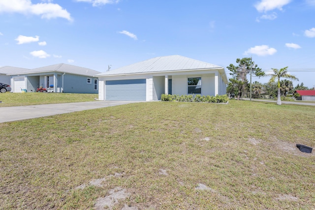 ranch-style home featuring metal roof, concrete driveway, an attached garage, and a front yard