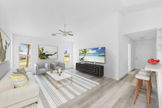 living area with baseboards, light wood-type flooring, visible vents, and a healthy amount of sunlight