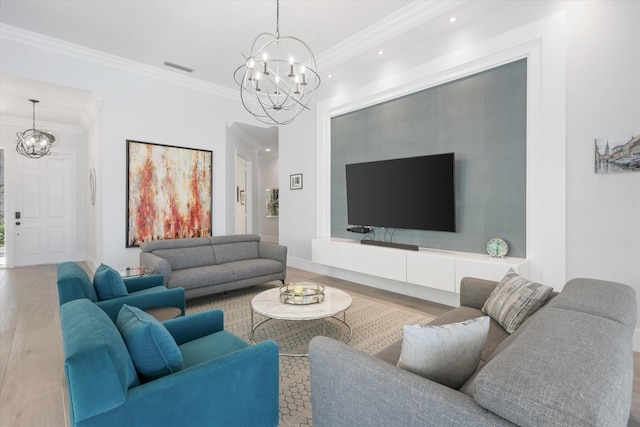 living room featuring visible vents, a notable chandelier, wood finished floors, and crown molding