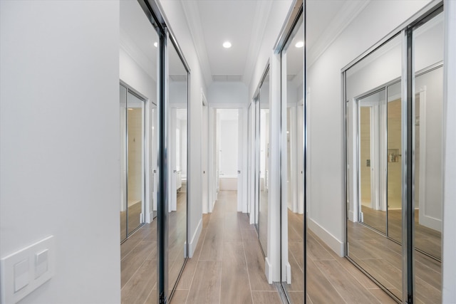 corridor featuring recessed lighting, baseboards, ornamental molding, and wood tiled floor