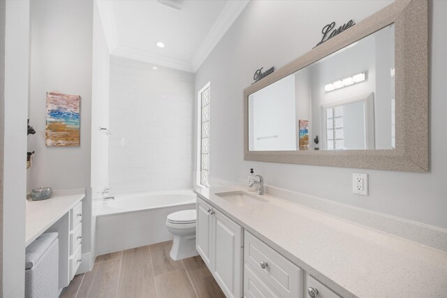 full bath featuring vanity, a tub to relax in, recessed lighting, ornamental molding, and toilet