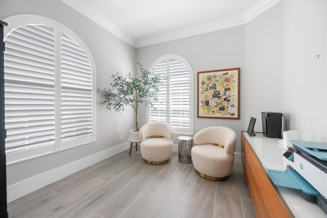 sitting room featuring crown molding, wood finished floors, and baseboards