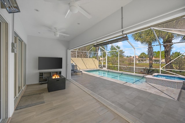 view of pool featuring ceiling fan and a pool with connected hot tub